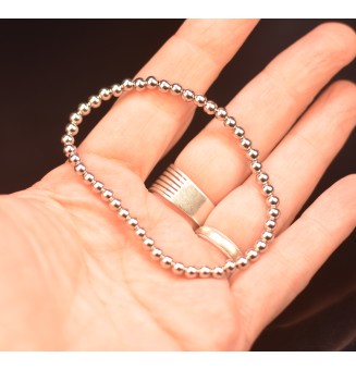 Bracelet élastique tout en  acier inoxydable, avec perles diam 4 mm acier inoxydable